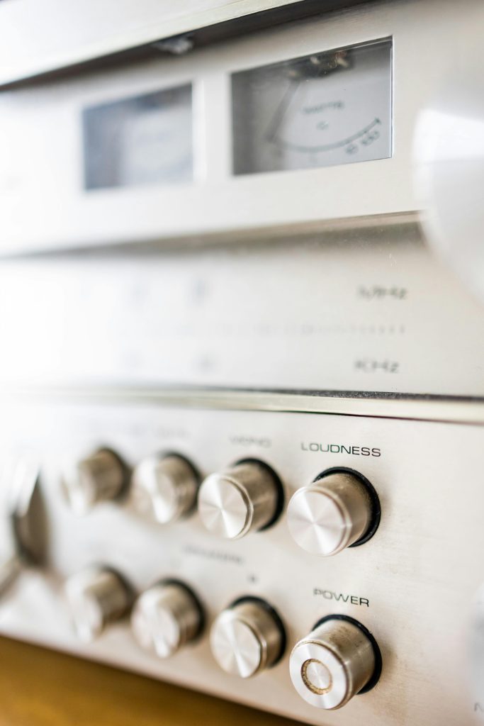 Creative design of audio stereo power amplifier with rows of knobs under volume meters with indicators
